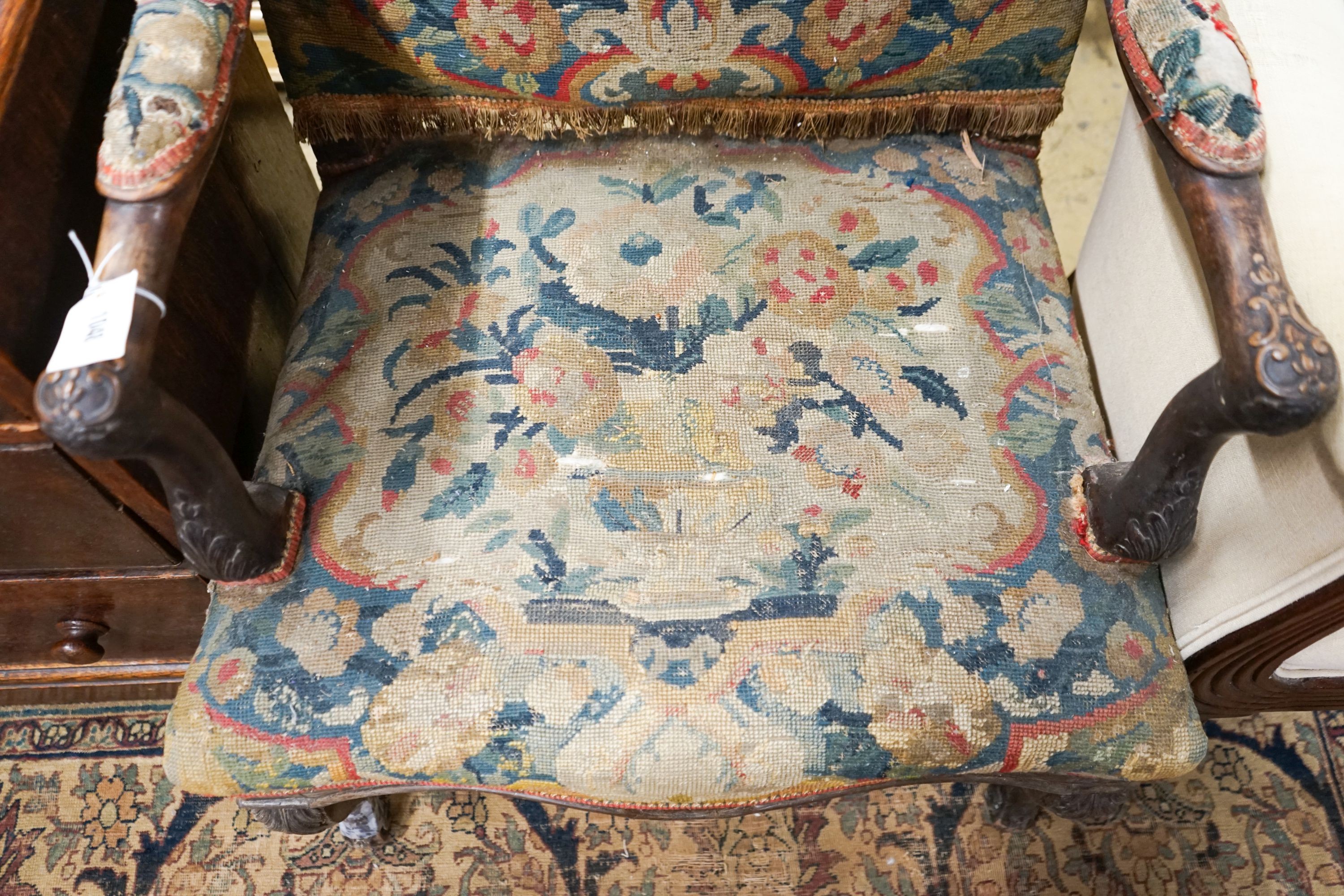 An 18th century French carved walnut elbow chair with tapestry upholstery, width 60cm, depth 58cm, height 104cm